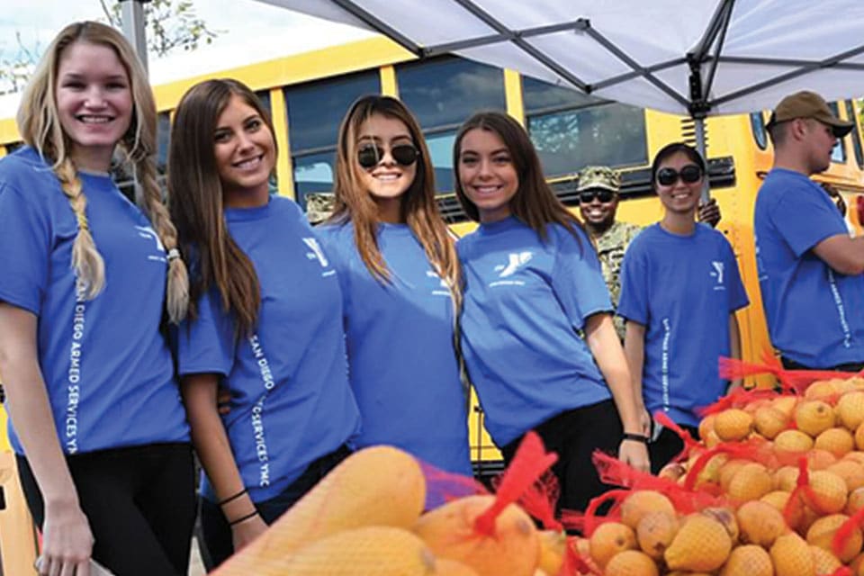 Volunteers help with a food distribution event in San Diego