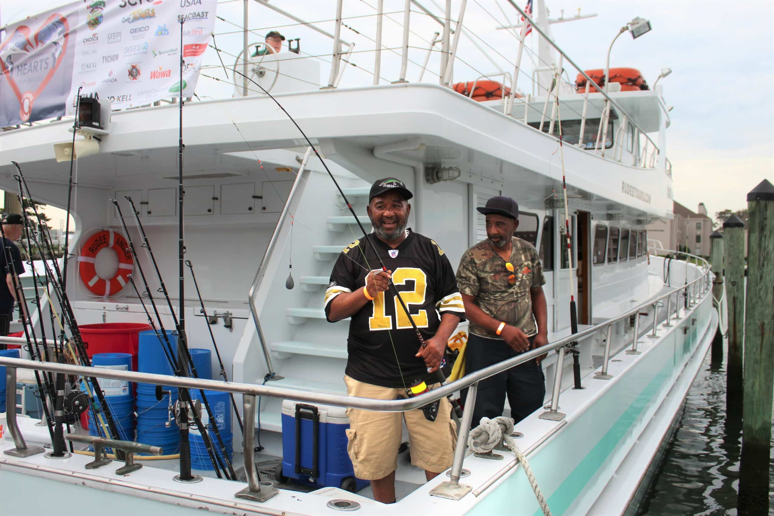 Man standing on fishing boat with fishing pole, ready for a day of fishing